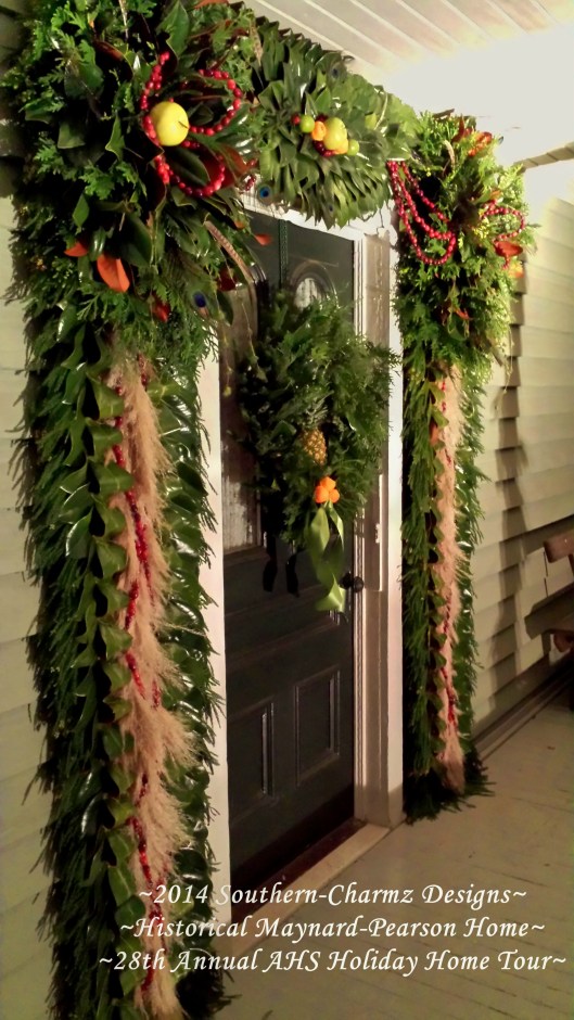 Angled view of the front door Christmas Designs showcasing fresh fruits and evergreens. Christmas is definitely on its way...!