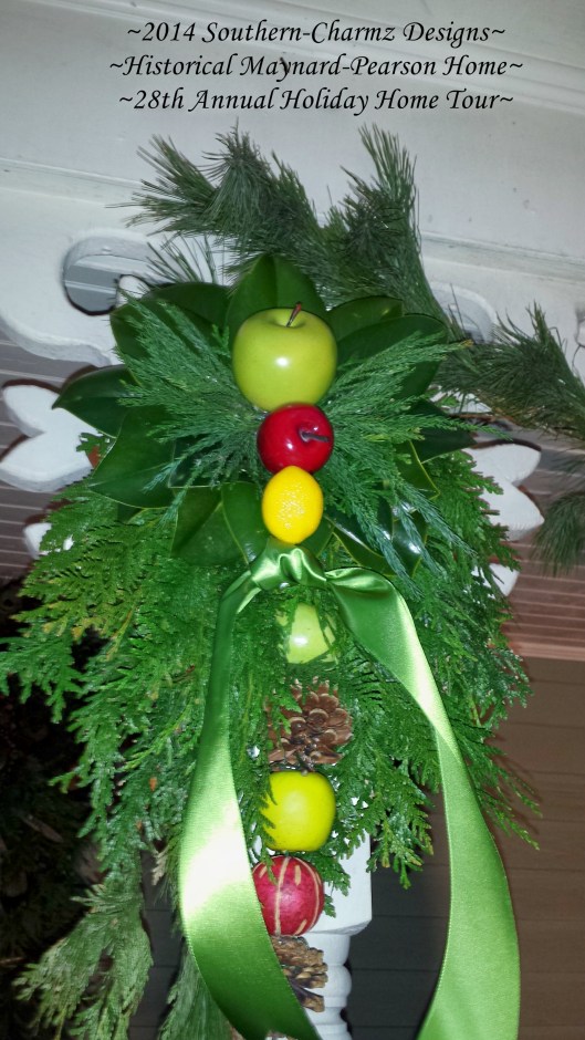 Delightful Evergreen Christmas Spray consisting of fresh Cedar, Magnolia, Conifer & White Pine, pinecones, green & red apples, lemons and pears.