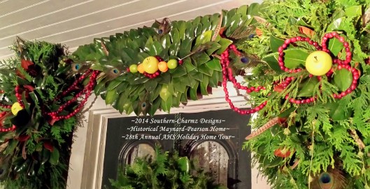 Evergreen topper close-up of the center magnolia crescent & side topper portions. This year's Christmas design showcases a variety of delightful Holiday fruits & evergreens consisting of: fresh magnolia leaves and boughs of cedar & conifer along with fresh fruits and wired fresh cranberries fashioned into flower petals and swags.